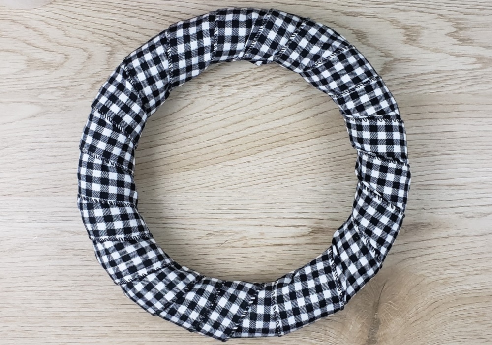 https://www.marchingnorth.com/wp-content/uploads/2019/12/wreath-wrapped-in-buffalo-plaid-ribbon.jpg