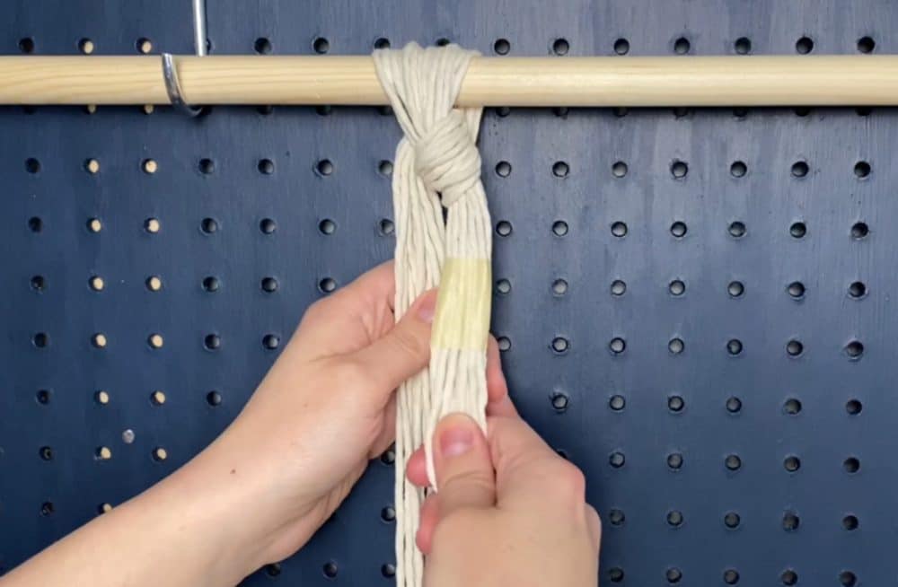 secure the cords to the dowel with a loose knot