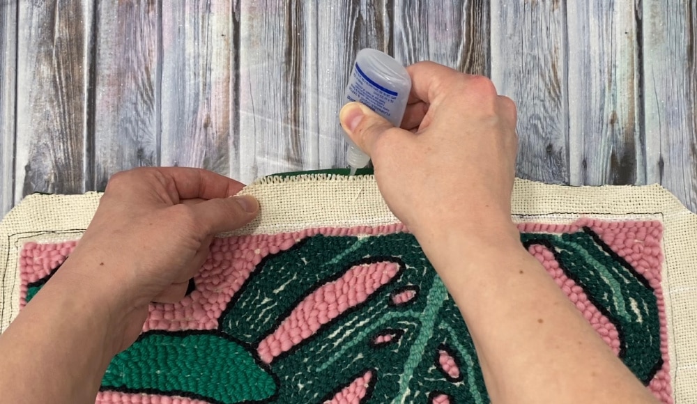 add fray check to the raw edges of punch needle pillow