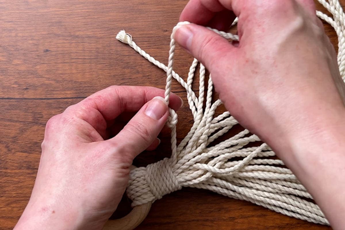 tying overhand knots in each cord end