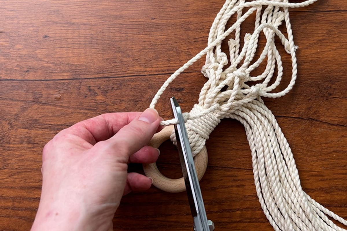 trimming excess cord just under the overhand knot